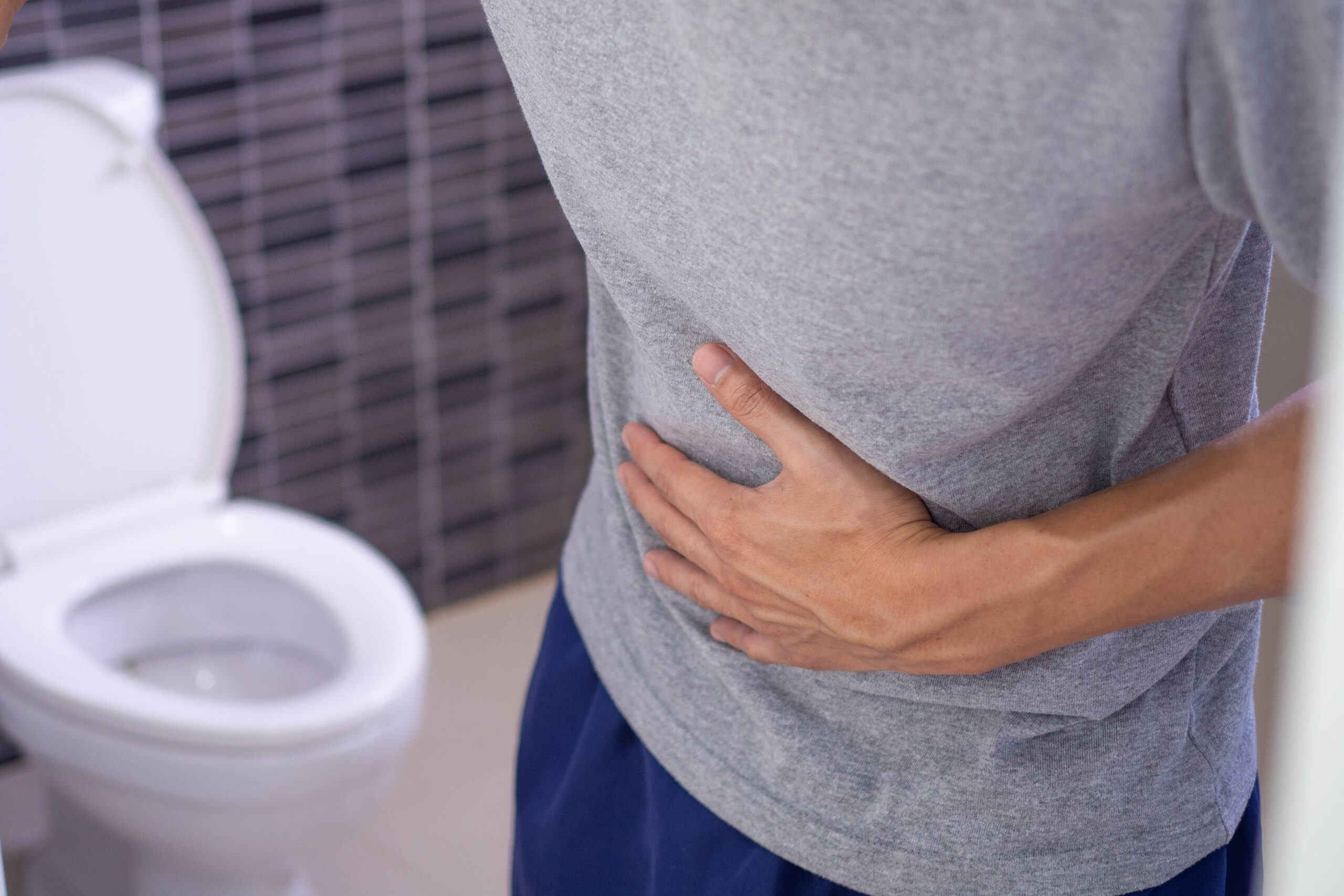 men-holding-hand-over-stomach-because-of-constipation